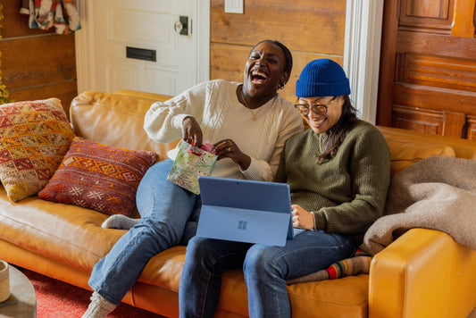 two people looking at computer and laughing